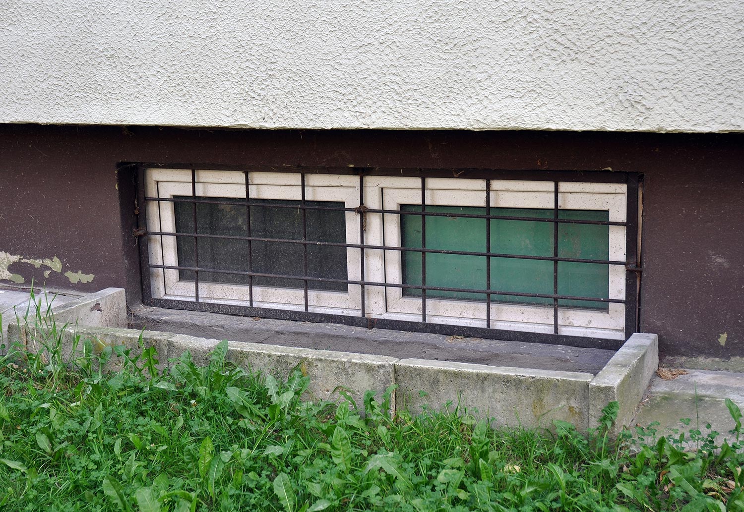 Barred basement window of a residential building