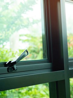 Black Window Latch Handle and a green nature, What Color Blinds With Black Windows? [ 5 Fantastic Options]