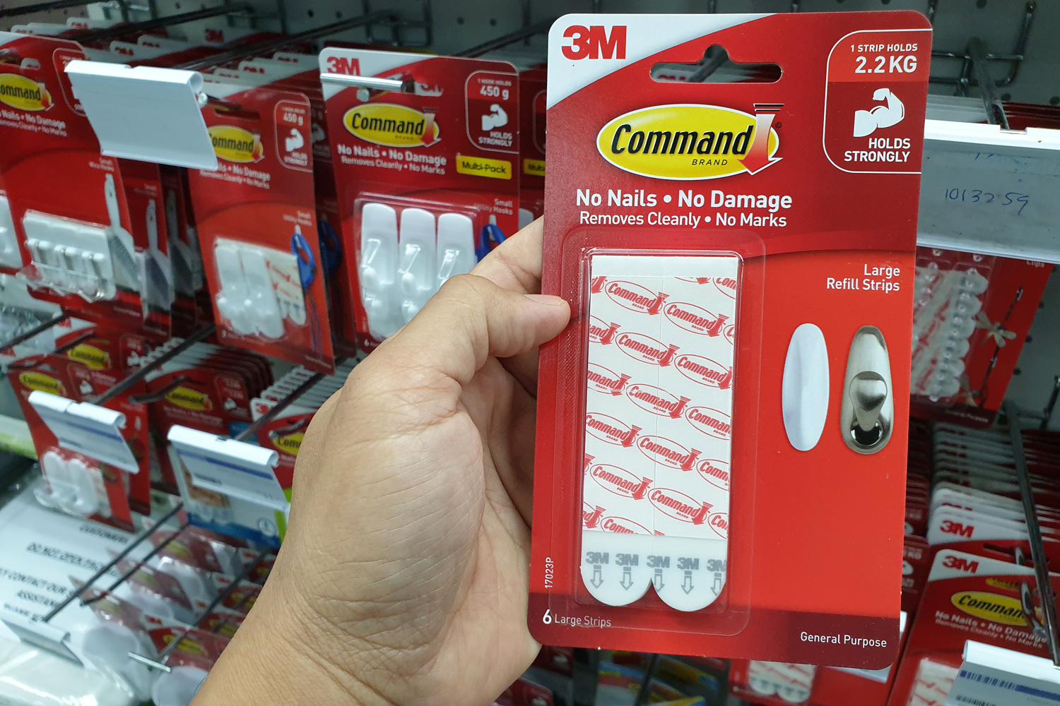Command brand Hanging Strips and Hooks by 3M company display on store shelf. 3M is the general public primarily known for the Post-it Notes and Scotch Tapes.