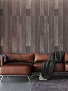Contemporary inspired living room with wooden paneled wall, brown leather sofa and gray tile flooring, 15 Gray Tile Living Room Ideas [With Pictures!]