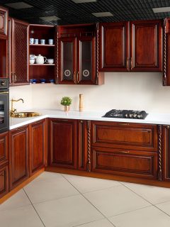 Dark cherry cupboards and cabinets at a rustic kitchen with white countertop and backsplash, How To Whitewash Cherry Furniture
