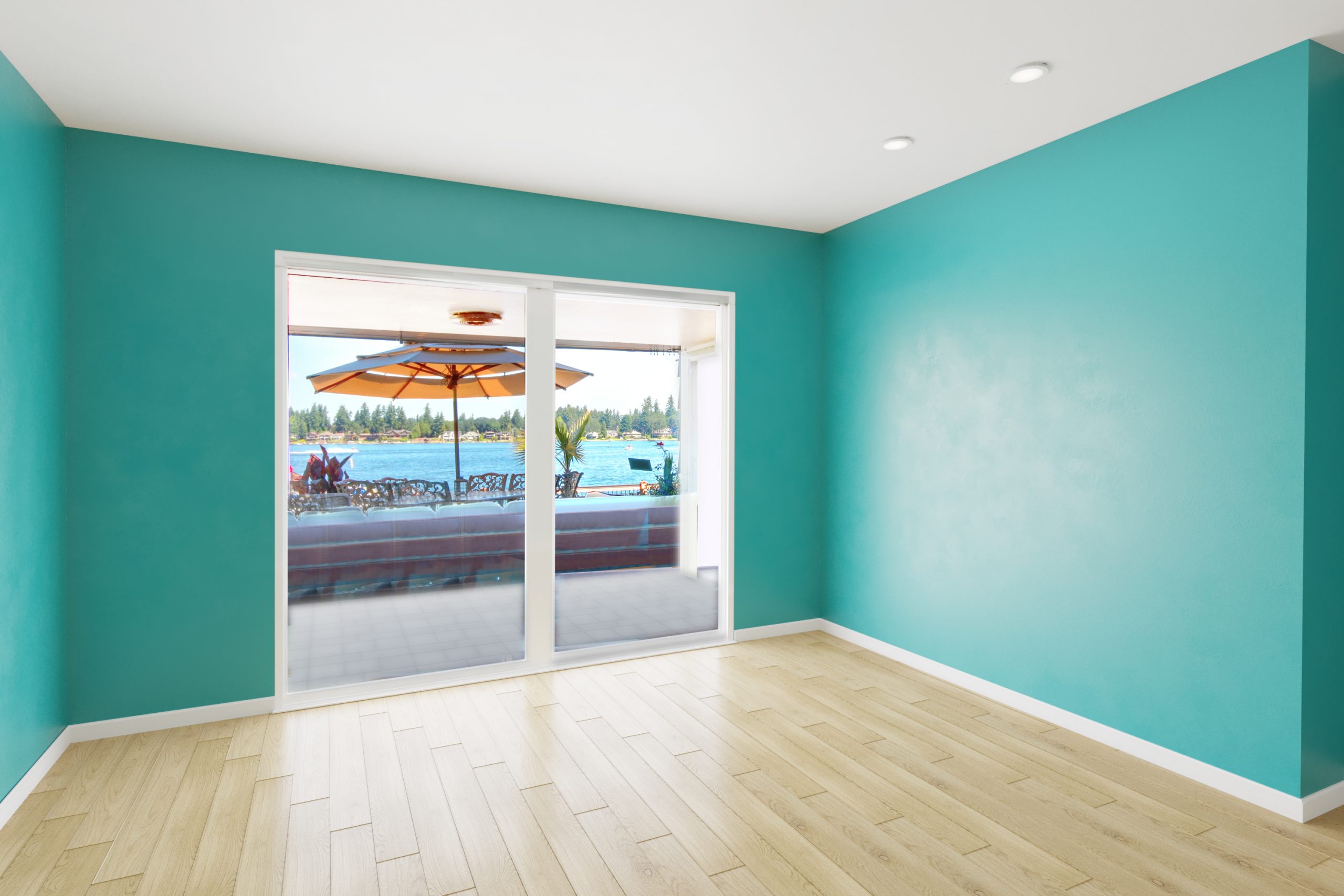 Small cozy beach side living room transformed with teal walls, no furniture