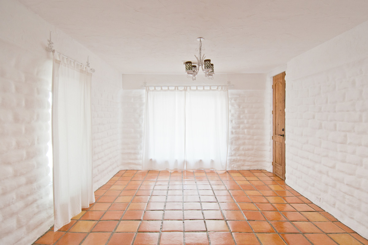 Empty Rustic Room with White Adobe Brick Wall and Tiles