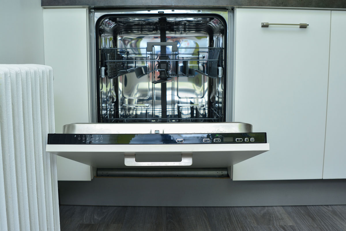 Empty opened dishwasher inside a modern kitchen