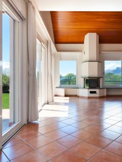 Glass sliding doors and white curtains with terracotta tile flooring, What Colors Go With Terracotta Tile?