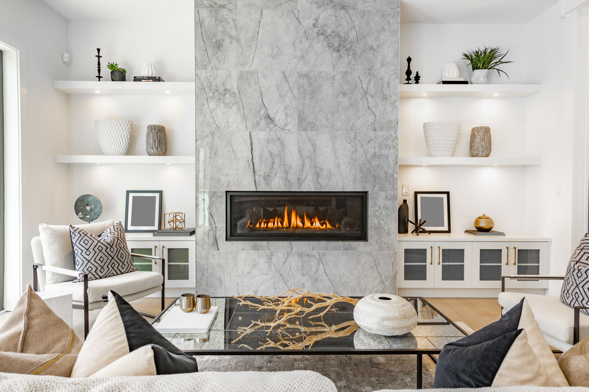 Gorgeous luxurious living room with a gray cladding fireplace and white walls and dividers