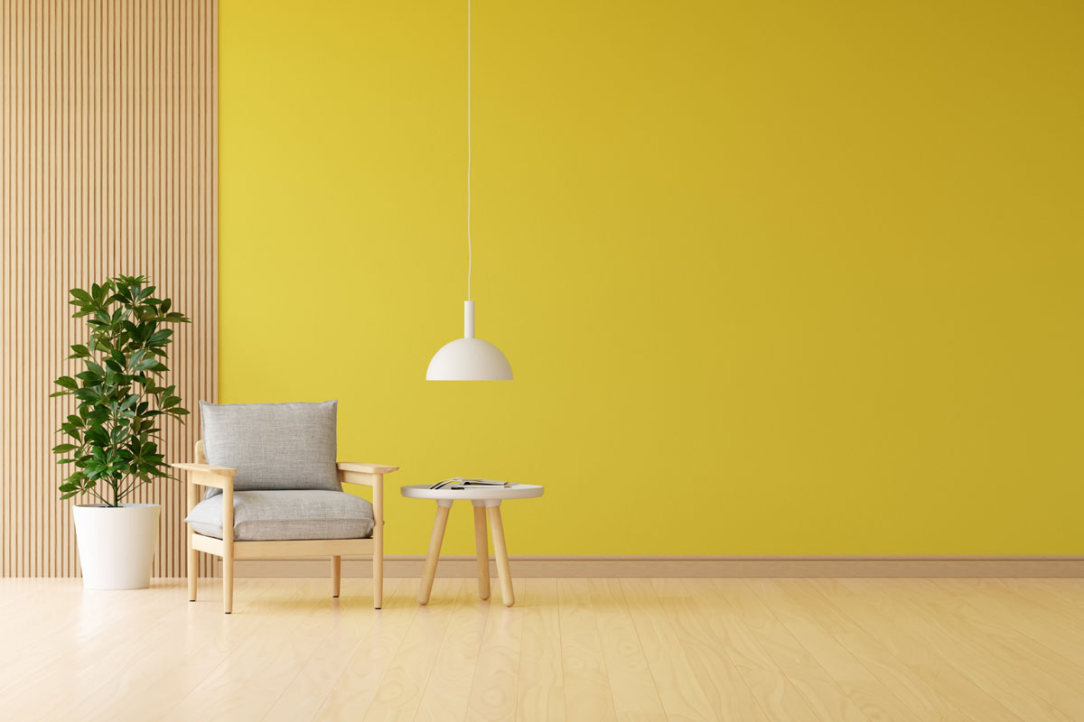 Gray armchair in yellow living room with free space for mockup
