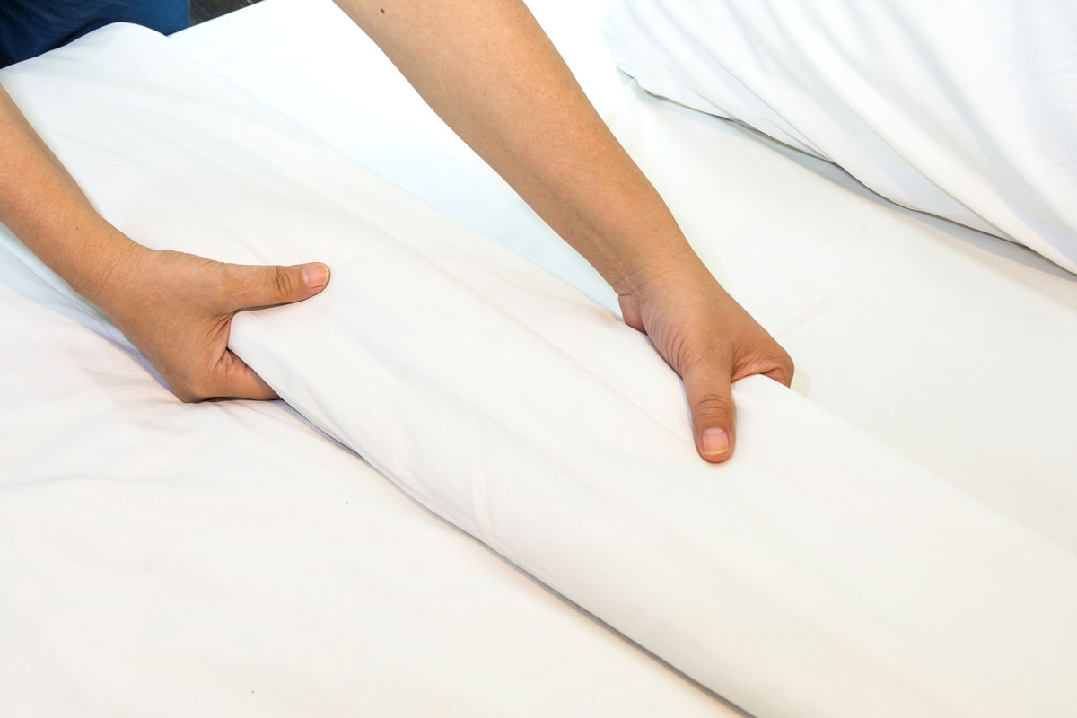 Hotel service folding bedsheets