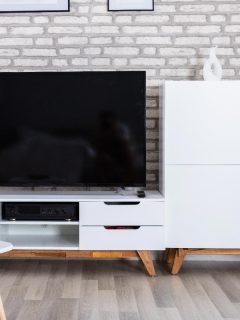 An interior of a living room with sofa and furniture, What Color Should I Paint My Entertainment Center? [11 Great Ideas!]