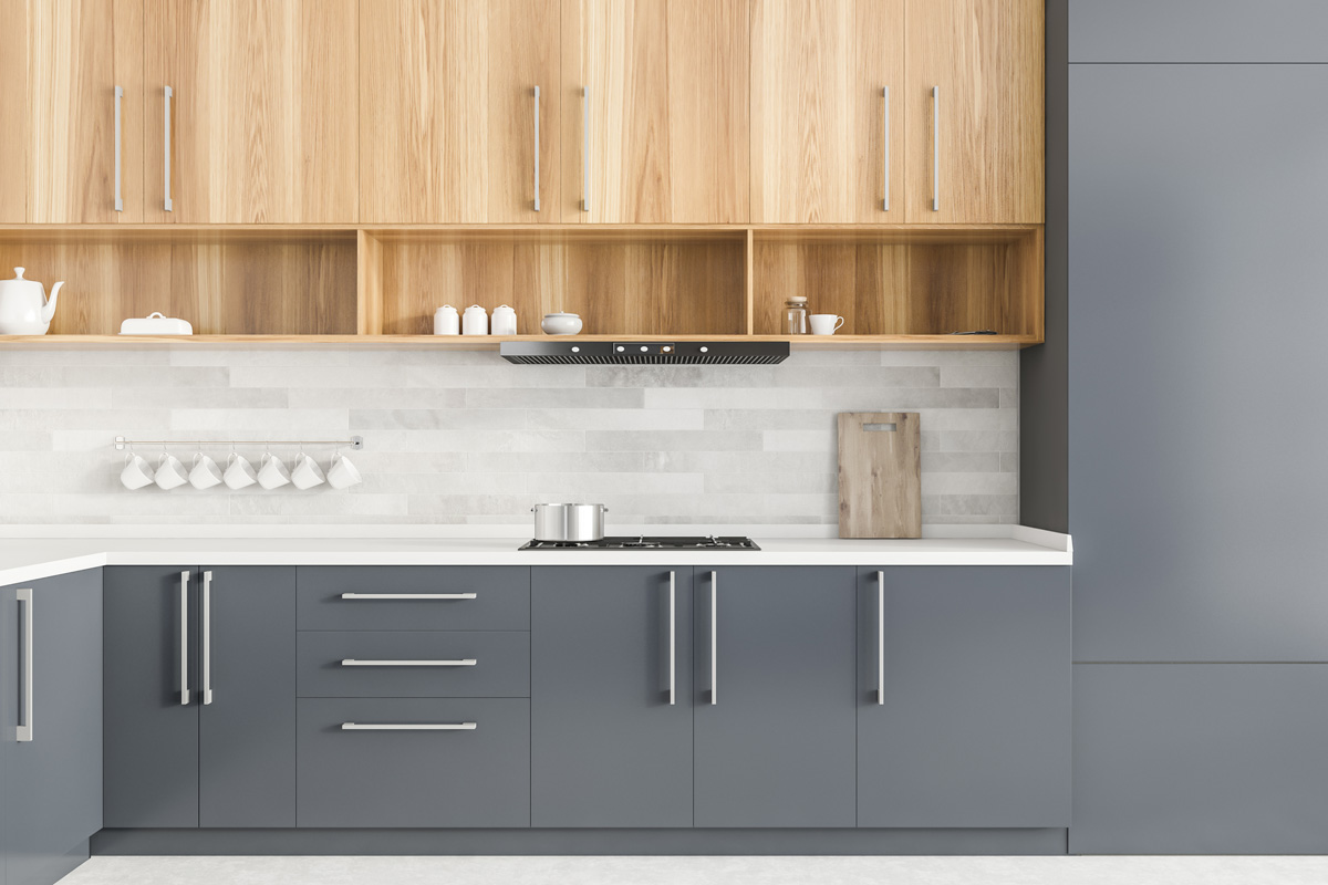 Interior of modern kitchen with gray and white walls, grey countertops and wooden cupboards