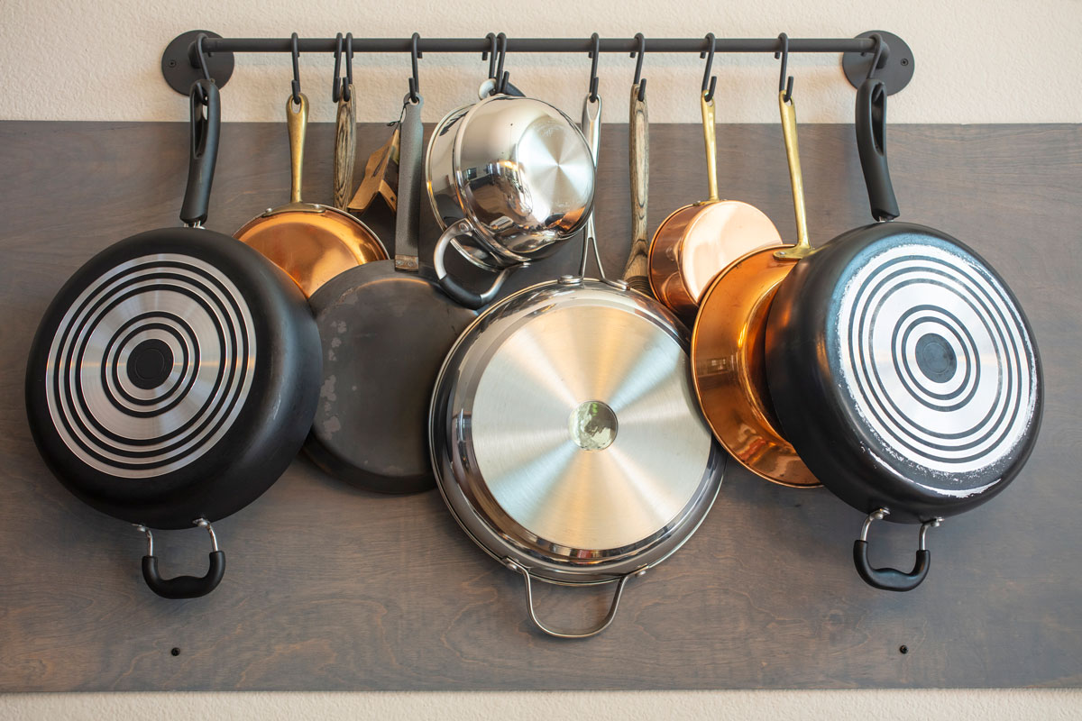 Kitchen wall rack for hanging pots, pans, aprons, and other utensils for storage and decor