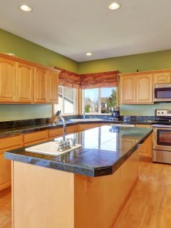 A kitchen with green walls and hardwood floor and maple cabinet, What Color Floor With Maple Cabinets?