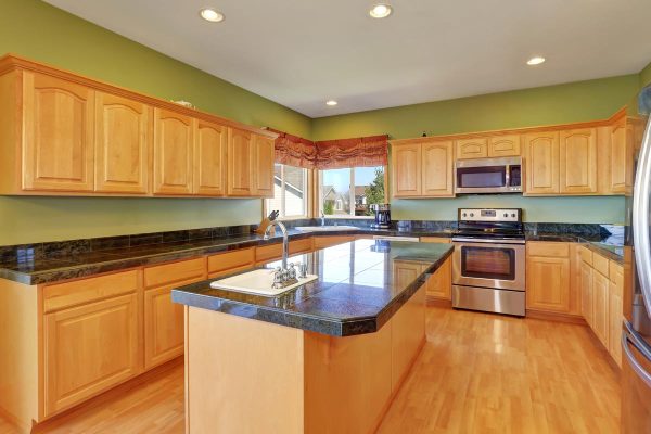 A kitchen with green walls and hardwood floor and maple cabinet, What Color Floor With Maple Cabinets?