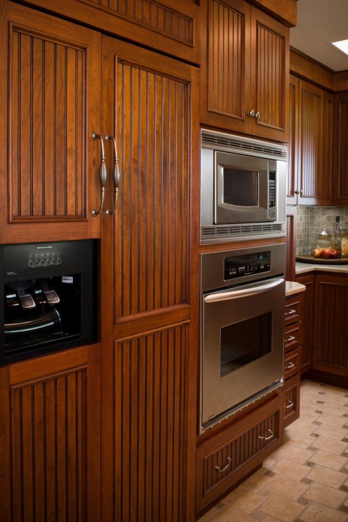 Kitchen with wood cabinets and ceramic tile flooring.