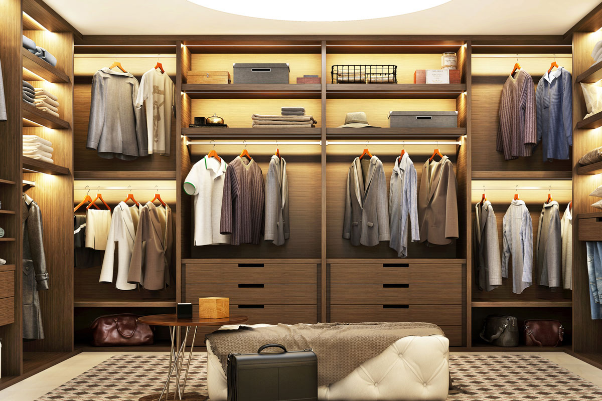 Large modern wardrobe with clothes with beautiful shelf lighting