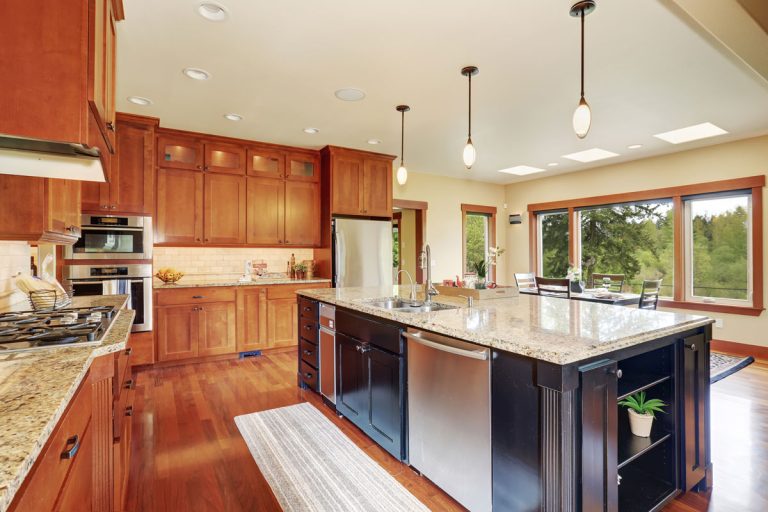 Luxury kitchen with bar style island, and hardwood floor, What Color To Paint My Kitchen Ceiling? [11 Options With Photos]