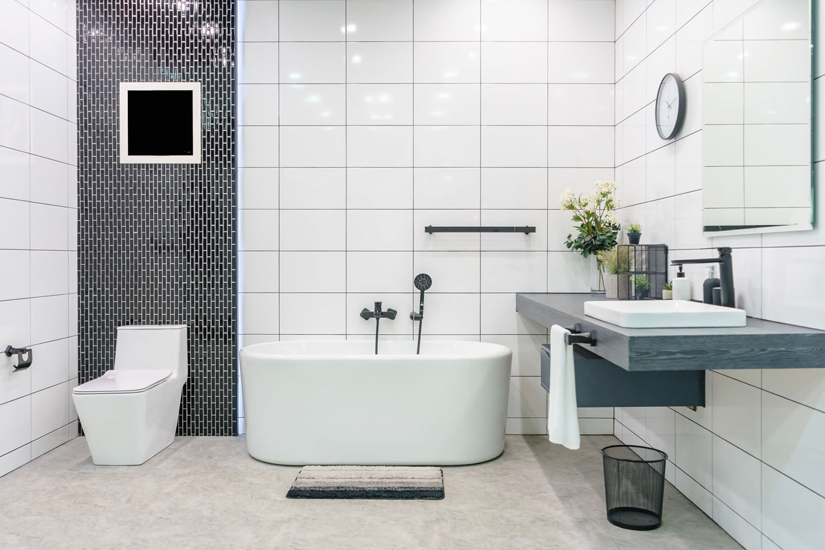 Minimalist inspired bathroom with solid tile tiles and a white bathtub
