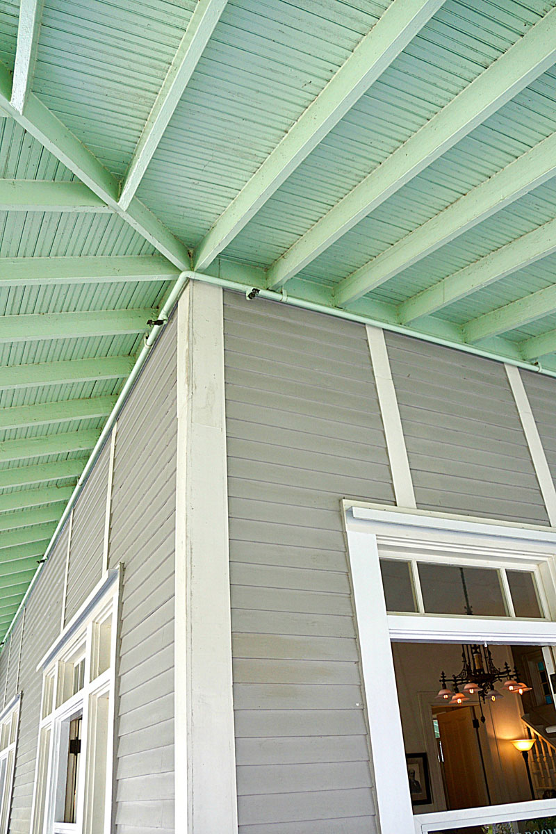 Mint green painted porch ceiling and matching gray and white vinyl sidings