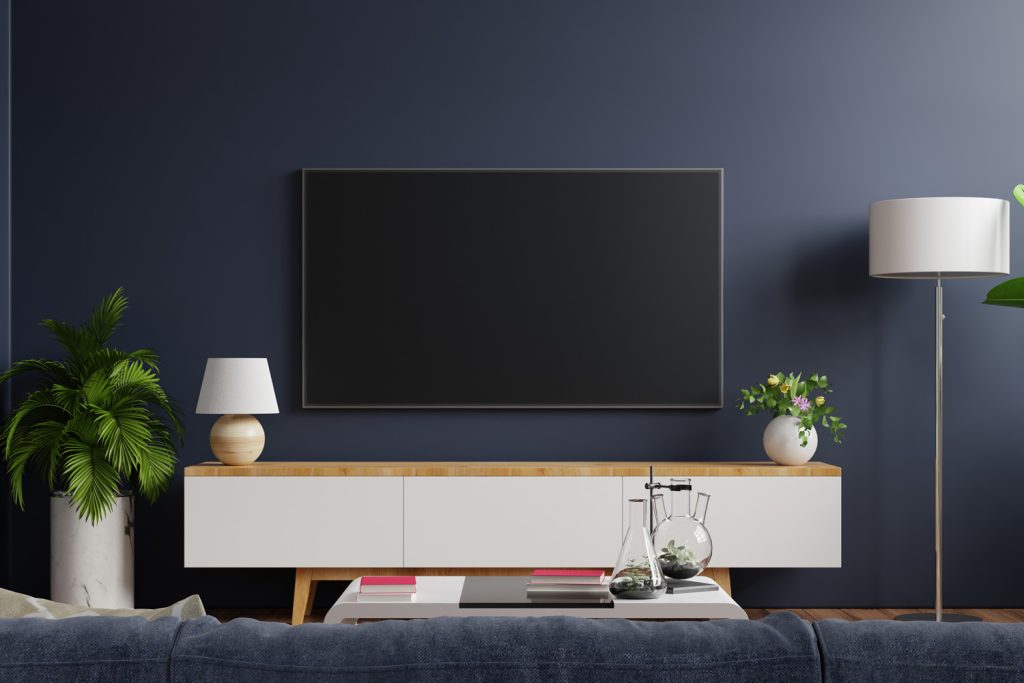 Mockup tv on cabinet in modern empty room with behind the dark blue wall.3d rendering