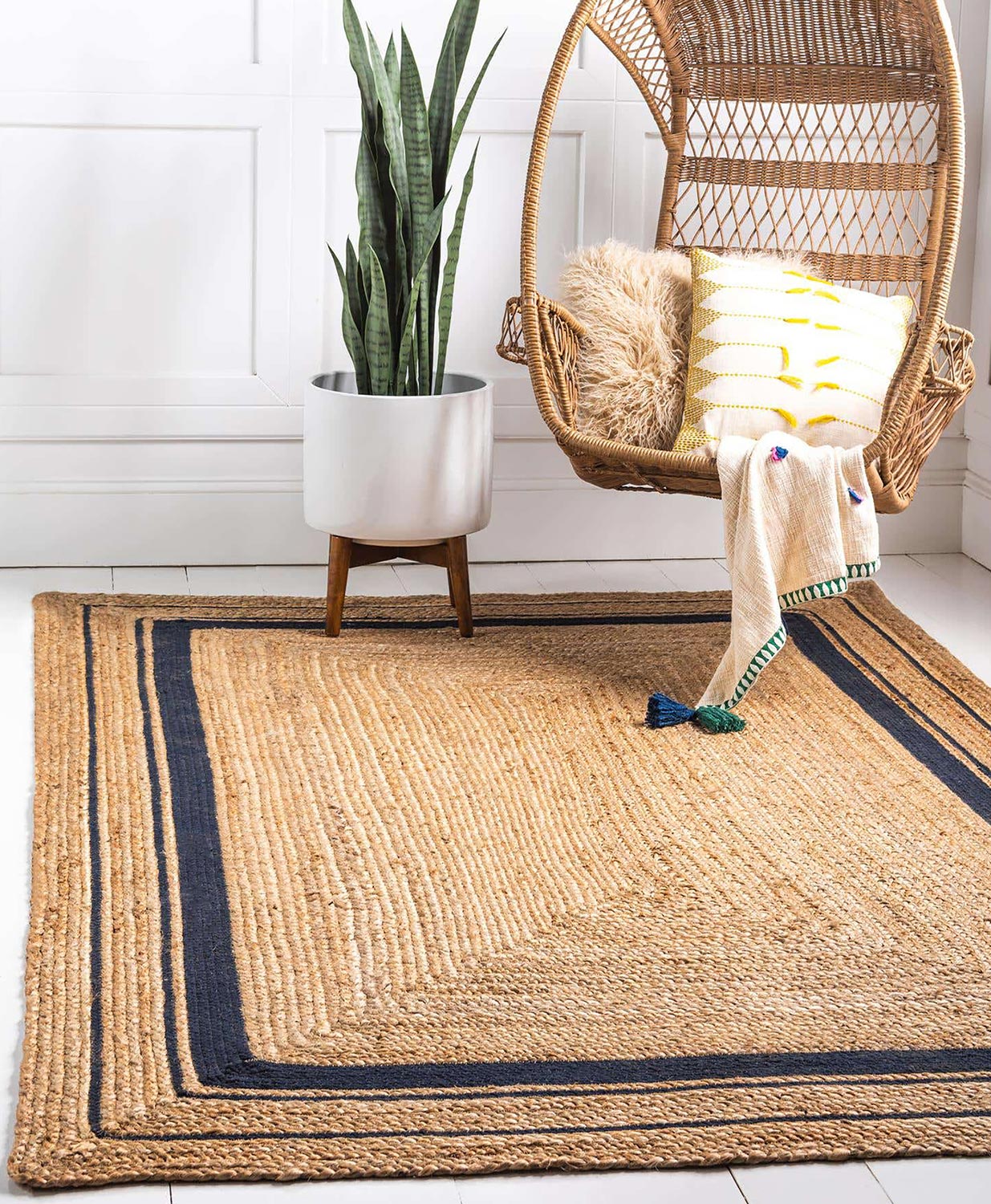 Modern natural braided jute living area rug design