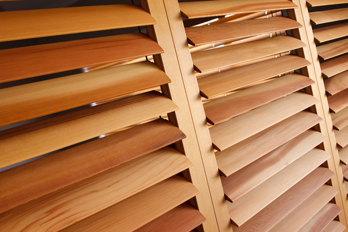 Brown Venetian blinds inside an office room of a smalla house