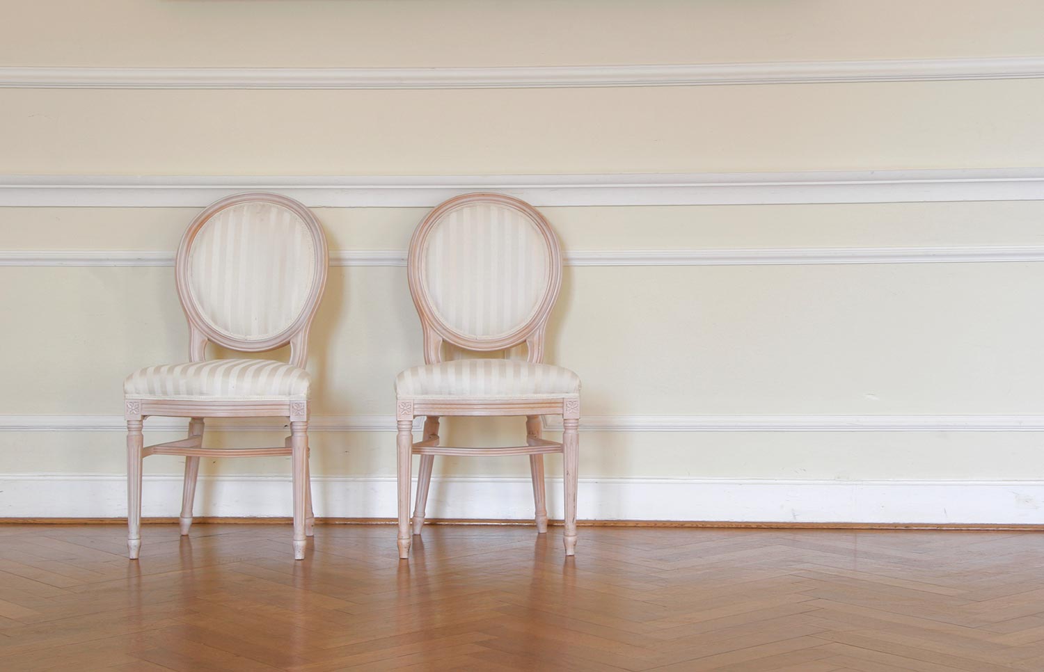 Pair of antic chairs in a classic interior setting