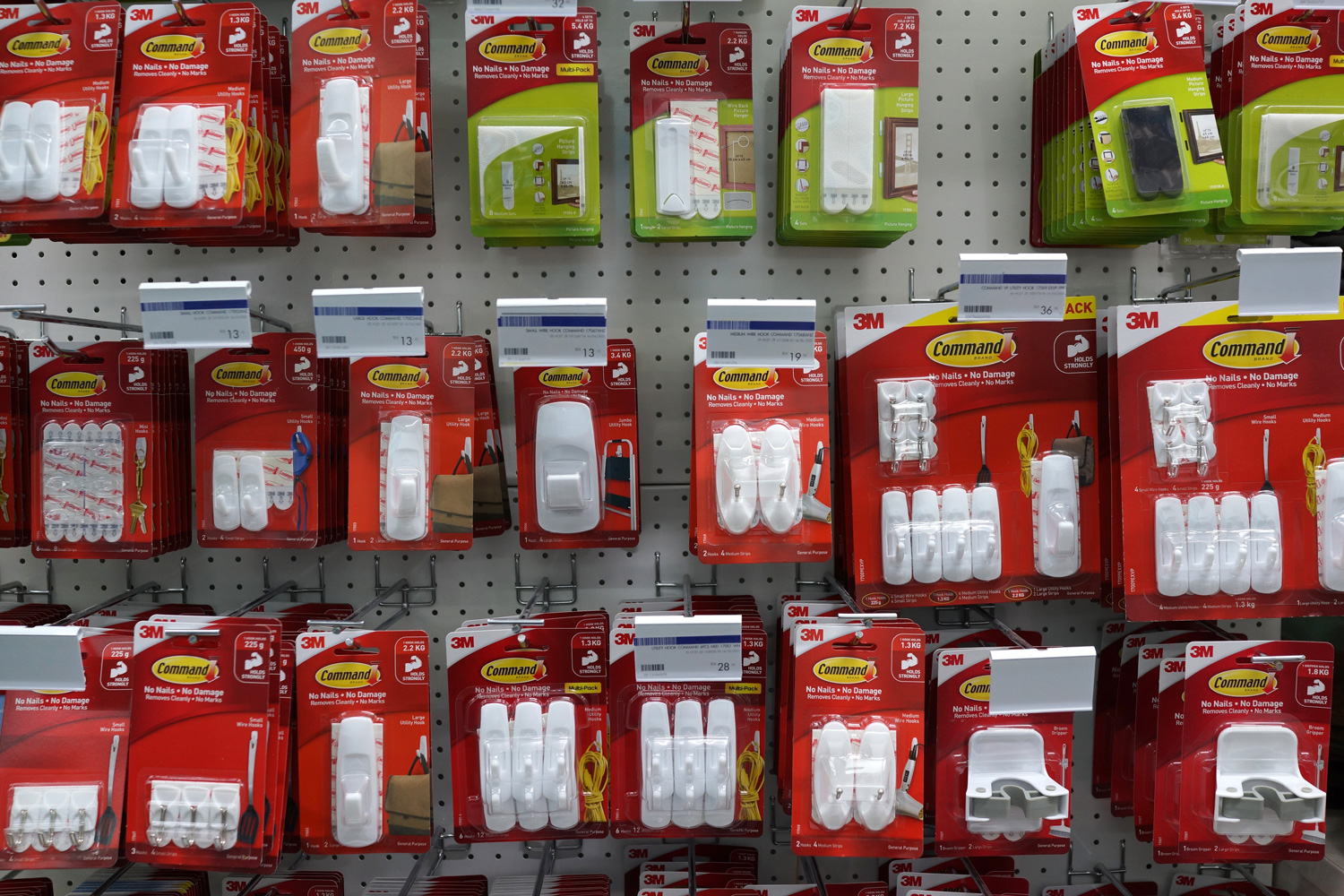 Row of Command brand Picture Hanging Strips and Hooks by 3M company on store shelf. 3M is the general public primarily known for the Post-it Notes and Scotch Tapes.