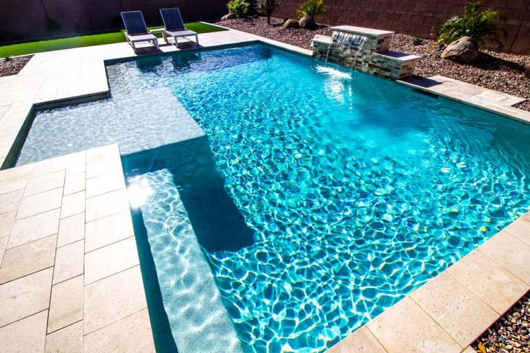 Residential pool in the back yard with two lounge chairs, How Deep Can A Residential Pool Be?