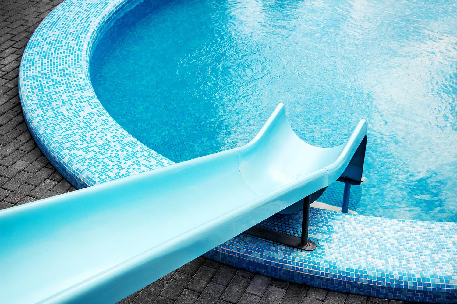 Round shaped swimming pool with blue water slide