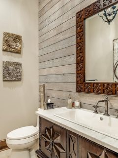 A rustic bathroom with a shiplap accent wall, Can You Put Shiplap Over Paneling?