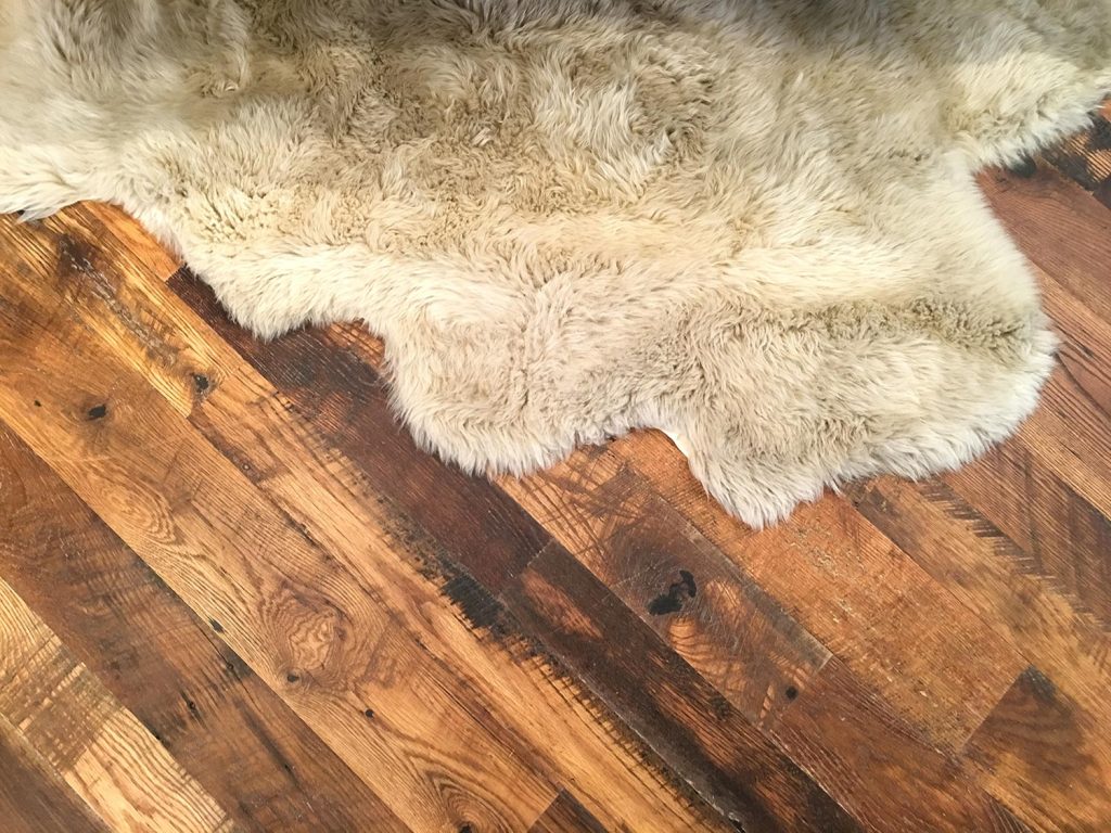 Sheepskin area rug on hardwood floor