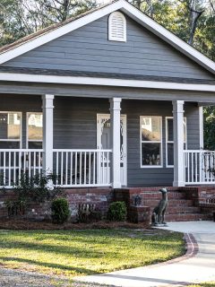 A small gray house with a front and side porch, 11 Front Porch Skirting Ideas