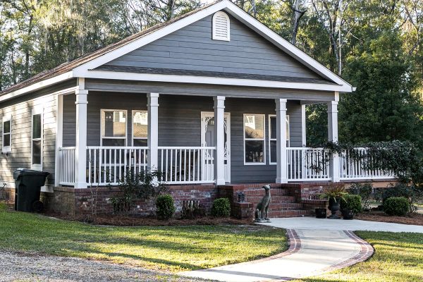 A small gray house with a front and side porch, 11 Front Porch Skirting Ideas