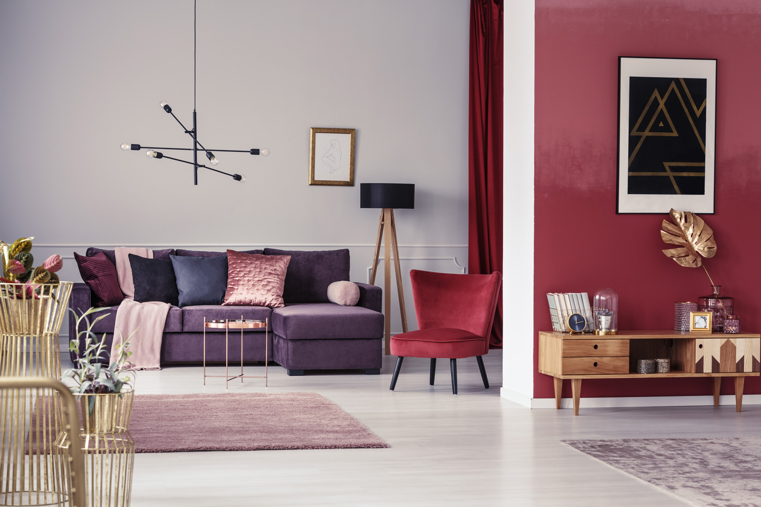 Spacious maroon apartment with corner sofa, red armchair and wooden cupboard