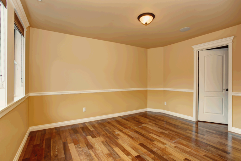 Unfurnished room with hardwood floor and yellow walls. 11 Two-Tone Wood Floor Designs To Inspire You