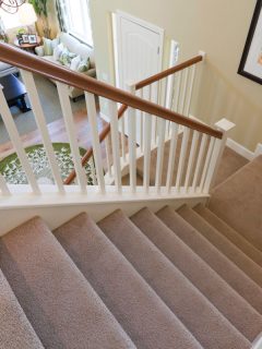 View down interior carpeted stairs in a modern American home, 11 Great Stair Carpet And Laminate Ideas