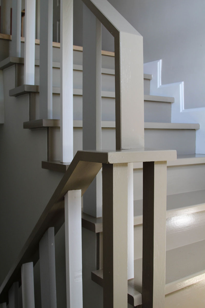 White painted stair banister with gray handrail