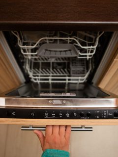 Woman opening dishwasher, What Size Appliance Pull For Dishwasher?