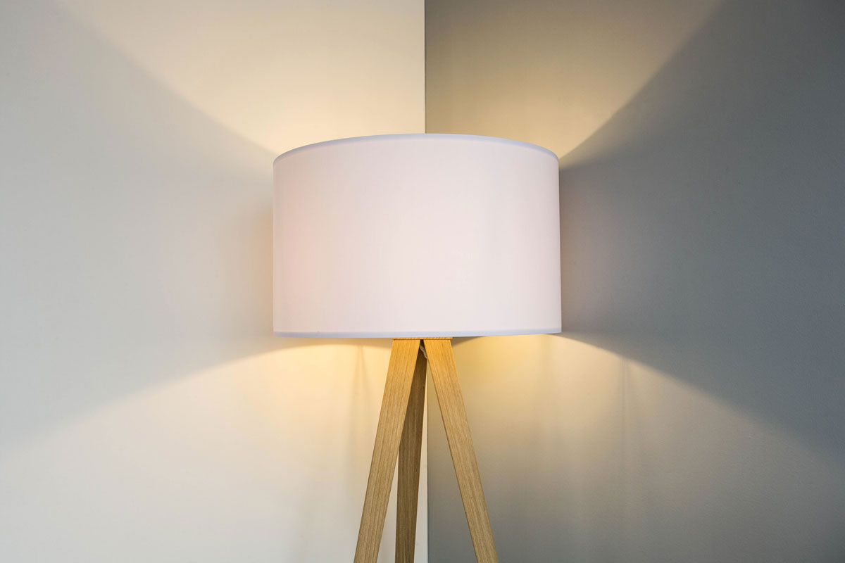 floor lamp standing near white gray wall with big lamp shade modern design, symmetrical light background texture