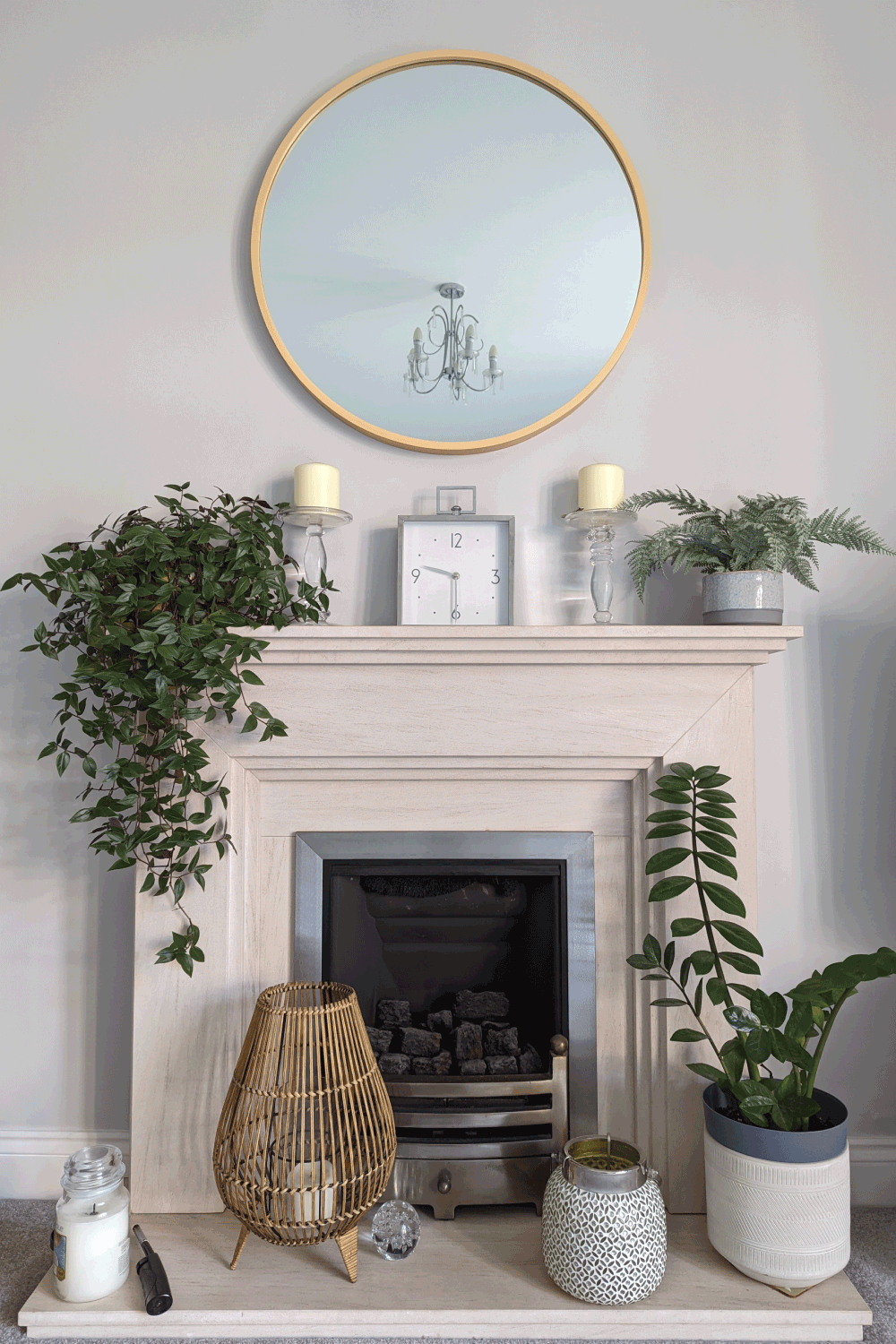 mirror with gold frame in top of an aesthetically pleasing fireplace