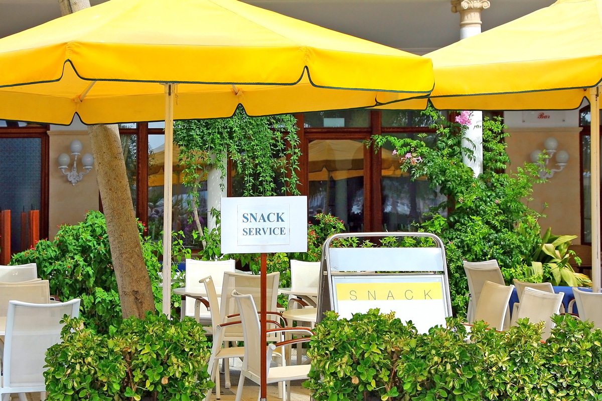 outdoor cafe with yellow sun umbrellas tables and chairs