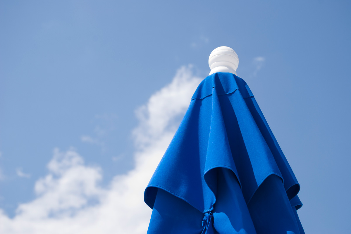 top of a closed beach umbrella