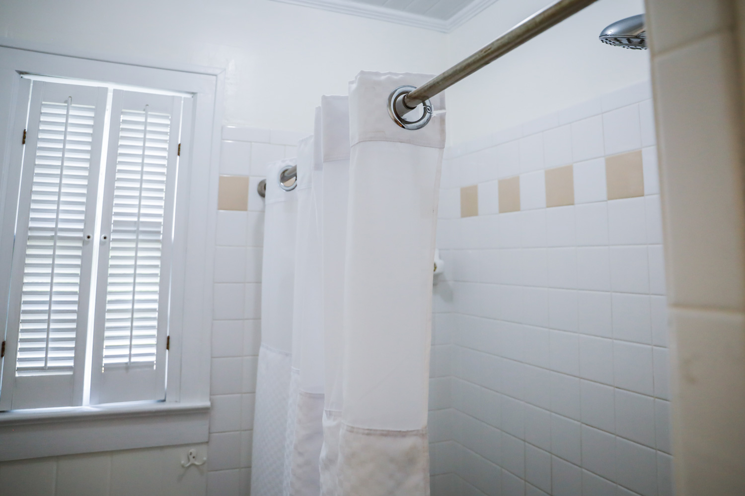 white bathroom shower with vintage tile in old cottage.