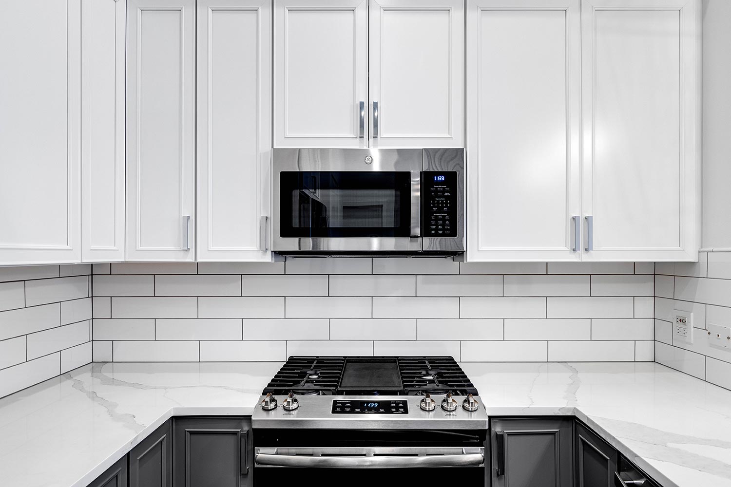 A detail shot of cabinets and stainless steel GE appliances in a small condo kitchen