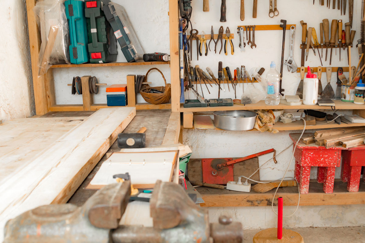 A garage filled with tools on the shelves and working table