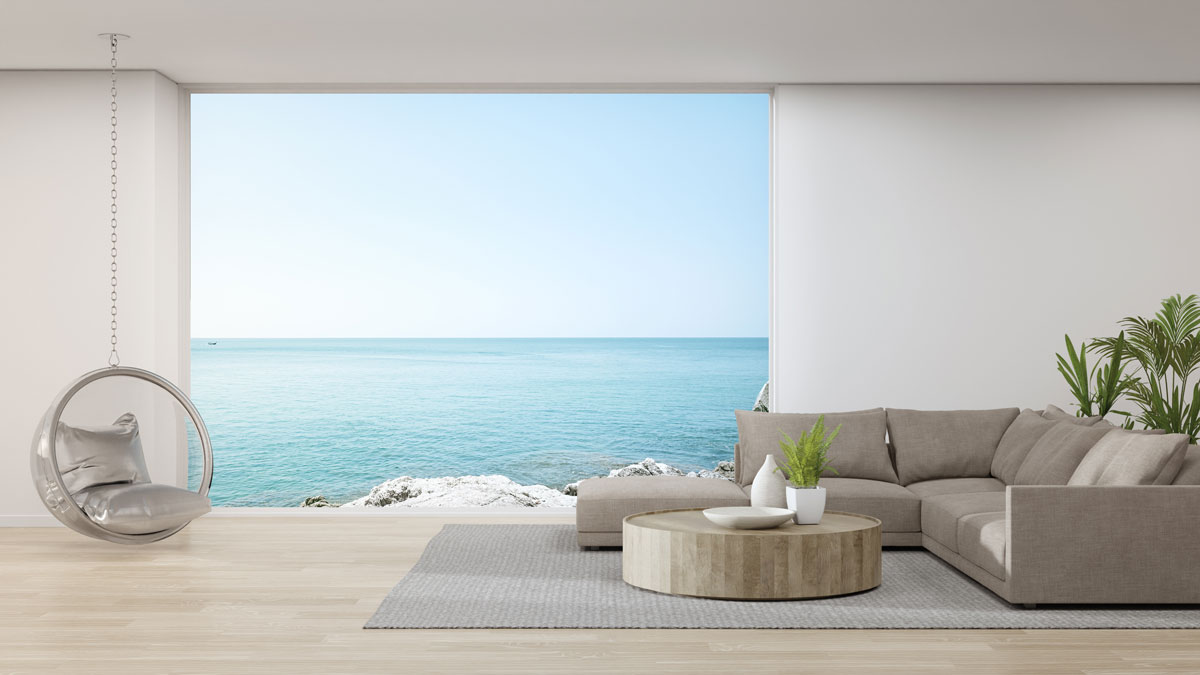 A luxurious living room with modern furniture's with a scenic view of the ocean