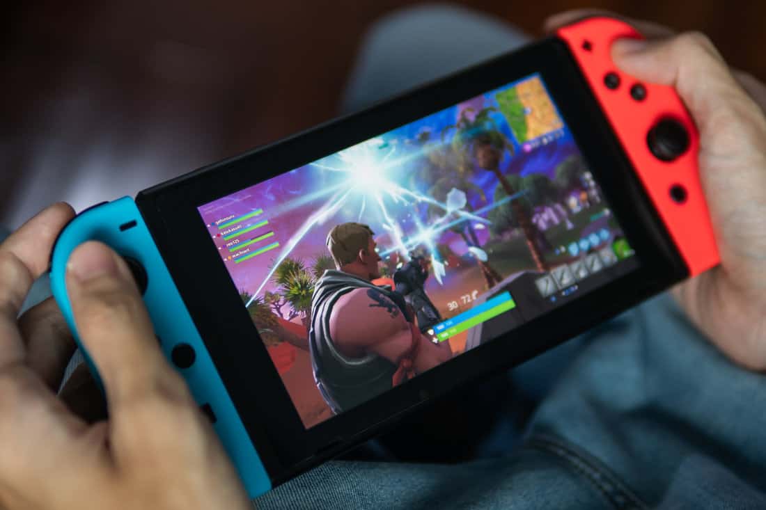 A man holding a Nintendo Switch game console.