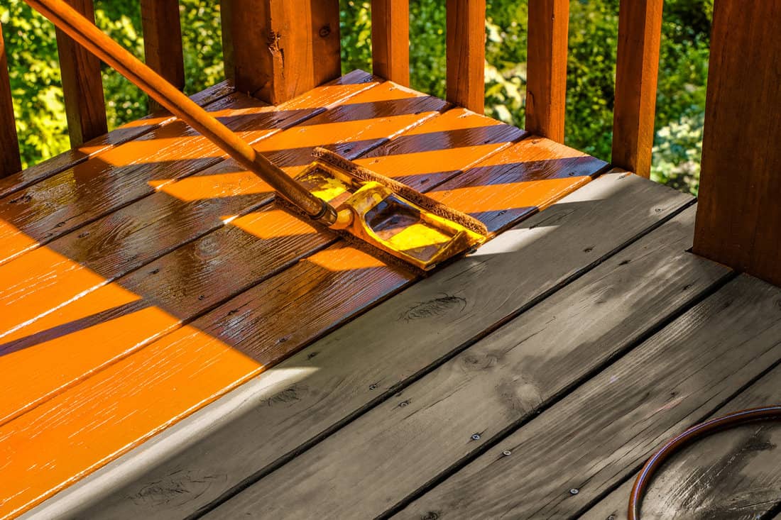 A process of staining wood of a wooden deck in the backyard