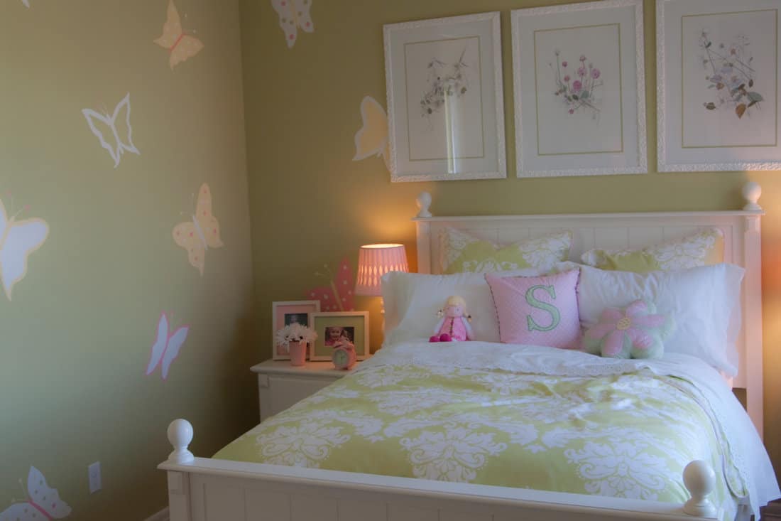 Adorable girl's bedroom with butterflies on the wall. 