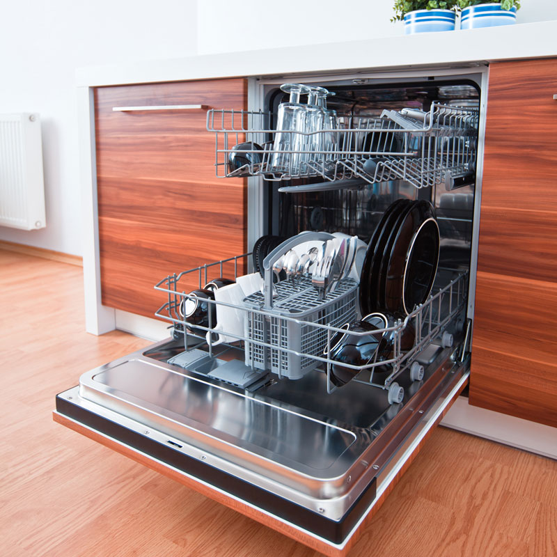 An opened dishwasher containing lots of newly washed dishes, glass and other utensils